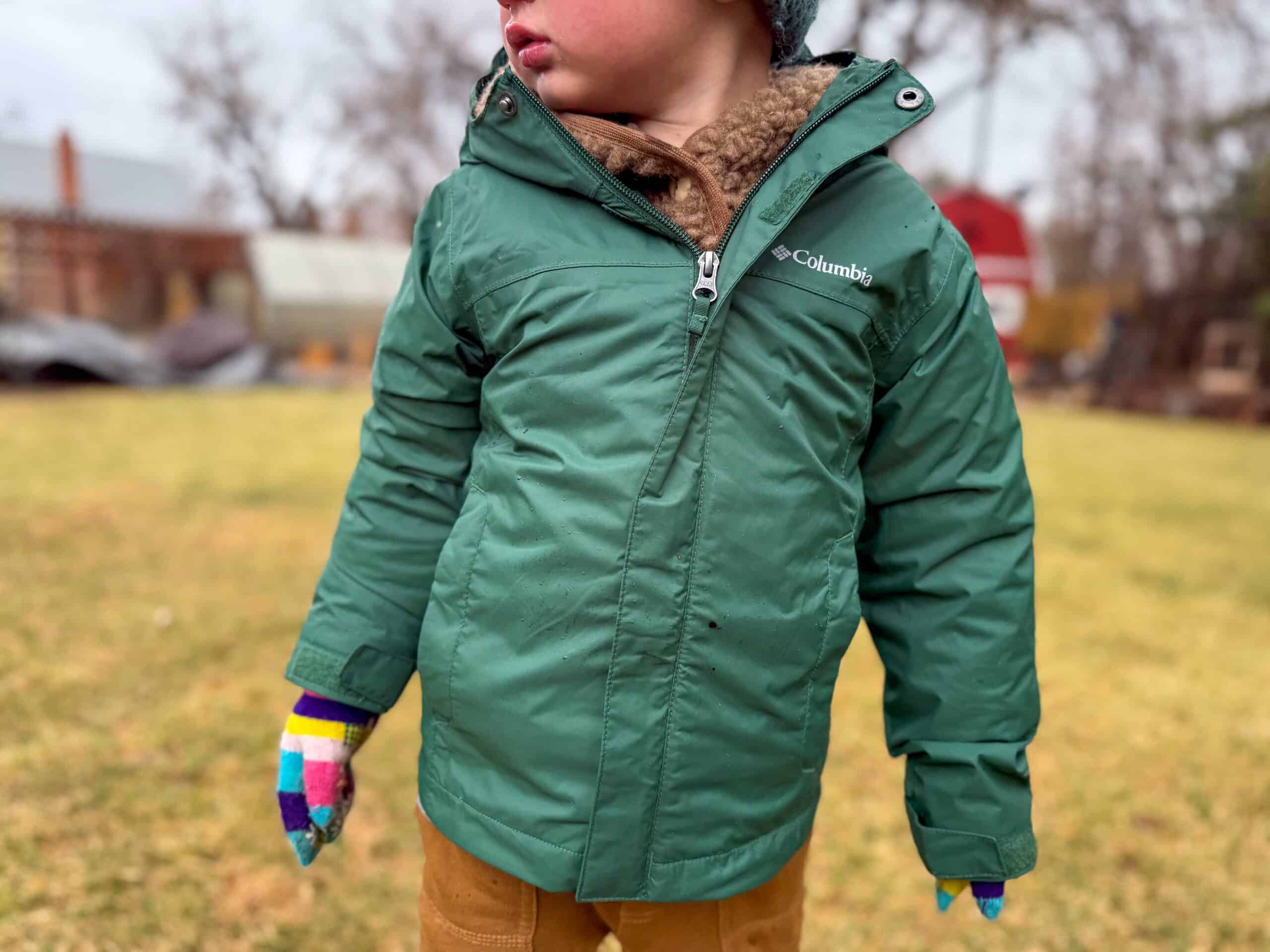 Toddler in green Columbia winter jacket outdoors