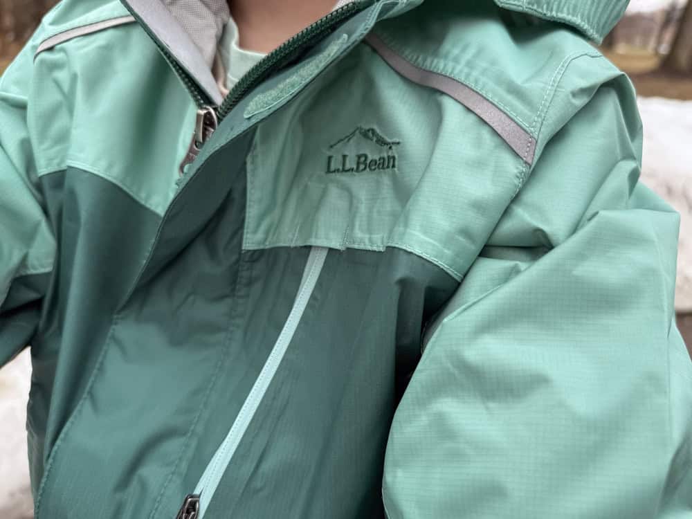 Child wearing teal L.L.Bean outdoor jacket closeup