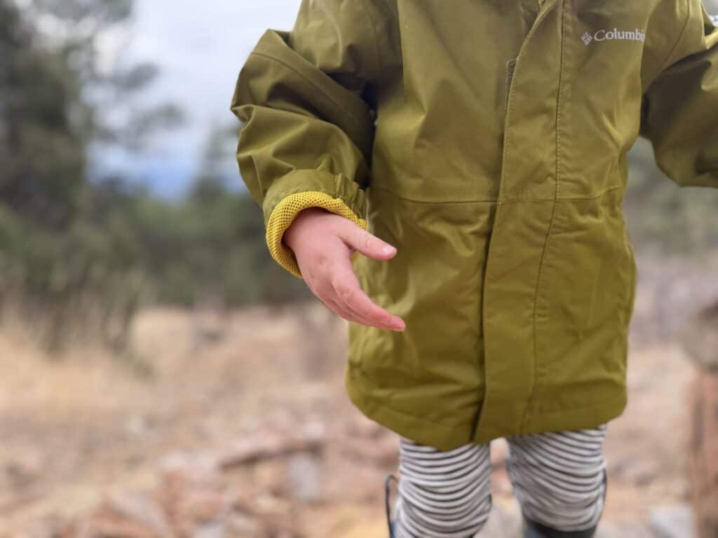 Close-up detail of Columbia Hikebound II Rain Jacket showing interior mesh cuff and Columbia logo on sleeve