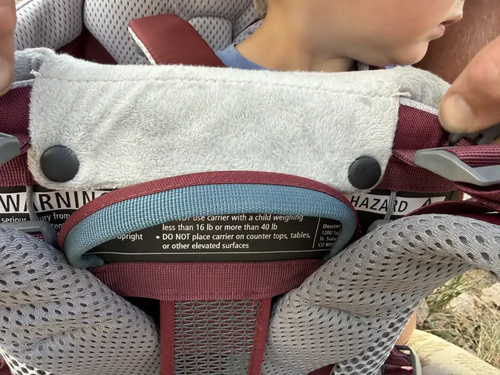 Removable chin pad snapped onto the front of the Deuter Kid Comfort child carrier cockpit