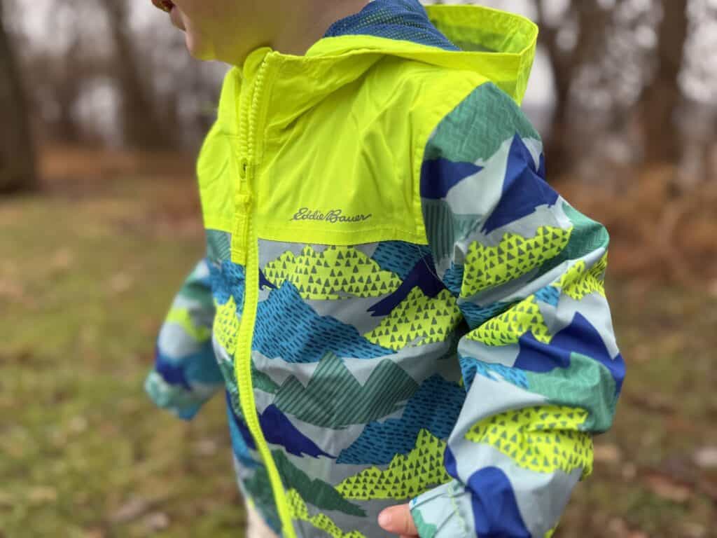 Front of the Eddie Bauer Toddler Rain Jacket showing the yellow yoke, logo and mountain print