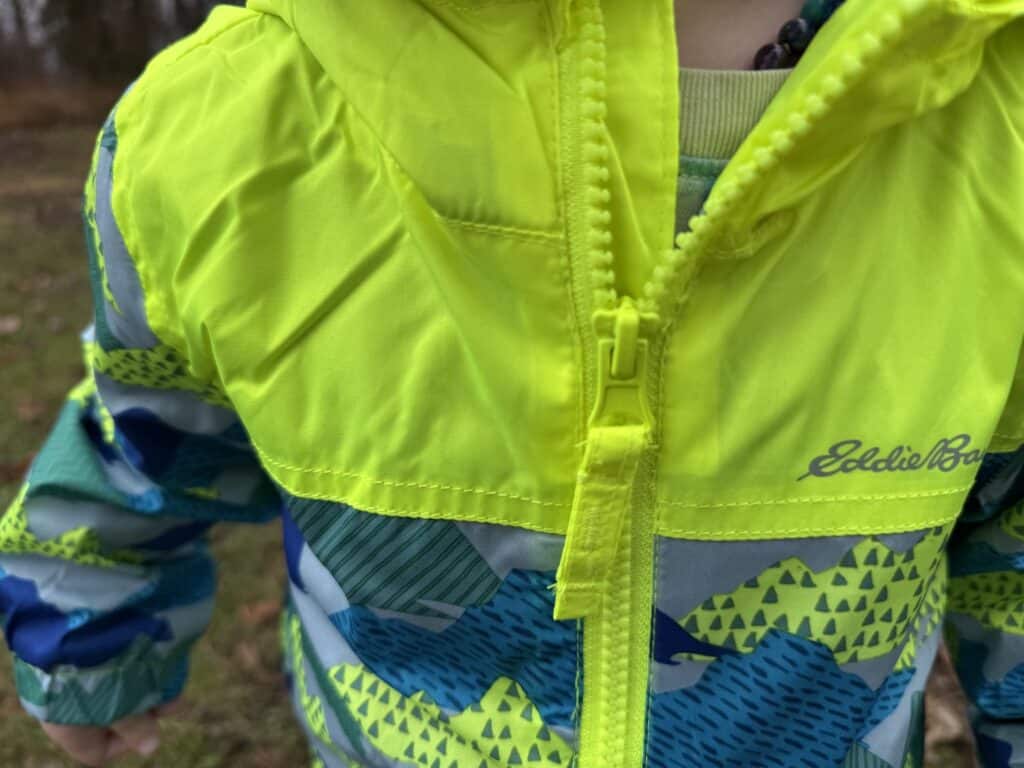 Close-up of the highlighter yellow zipper and pull on the Eddie Bauer Toddler Rain Jacket