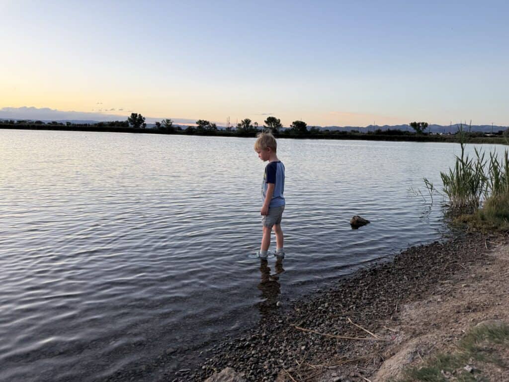 Kid standing ankle deep in a lake near Fruita, Colorado in KEEN Targhee IV Low Waterproof shoes