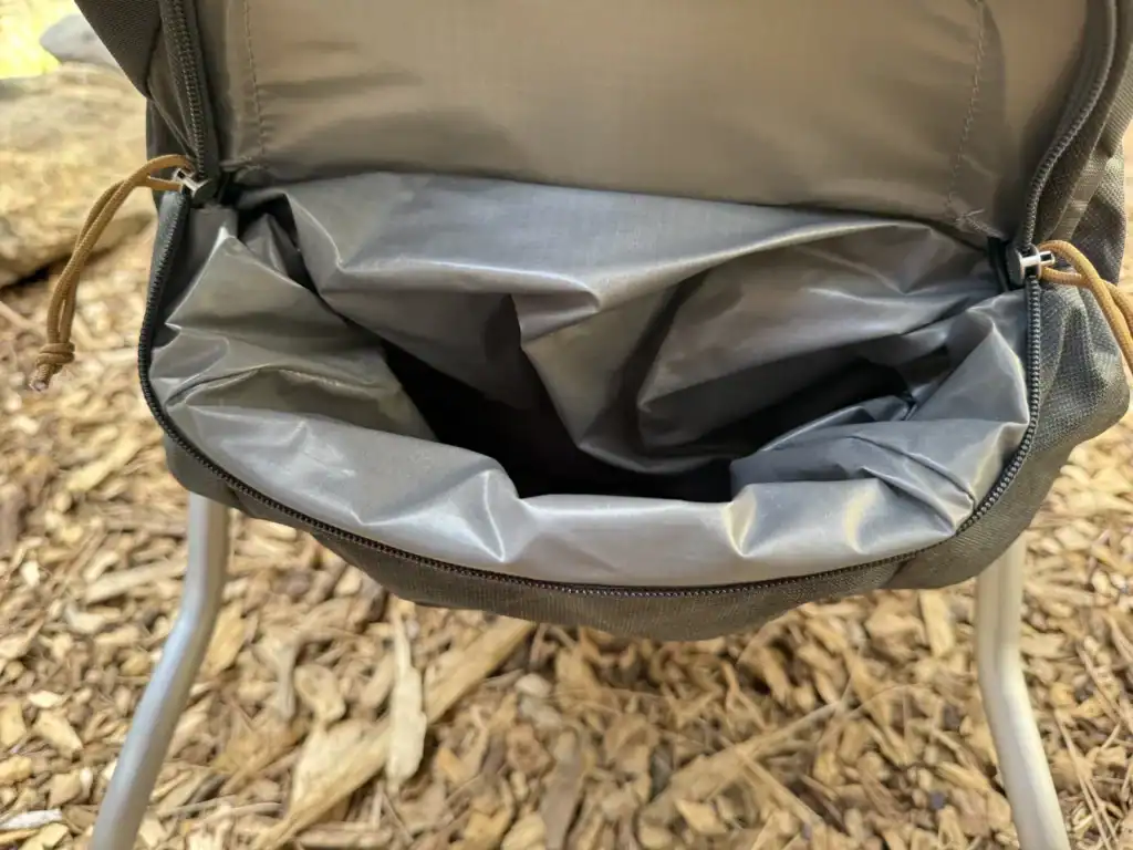 Open lined dirty gear compartment on the Kelty Journey PerfectFIT Elite child carrier