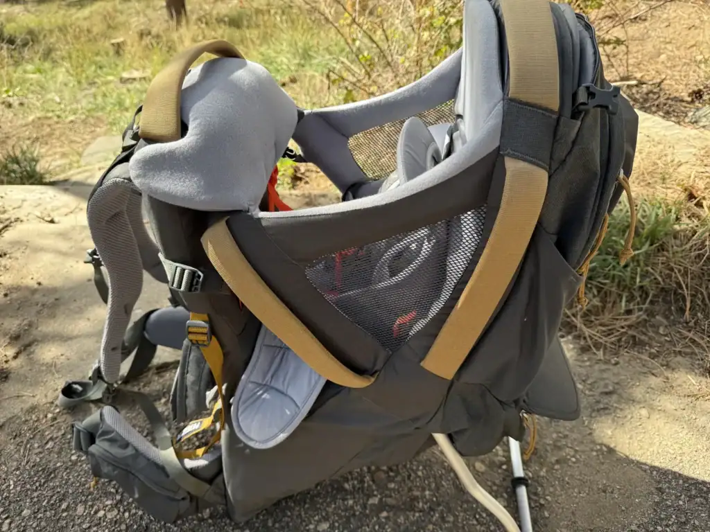 Kelty Journey PerfectFIT Elite child carrier standing on its kickstand outdoors