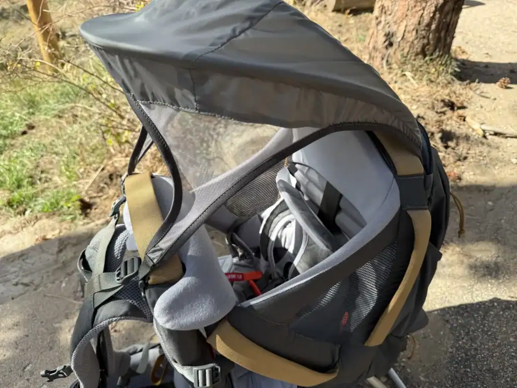 Integrated sunshade deployed over the cockpit of the Kelty Journey PerfectFIT Elite child carrier