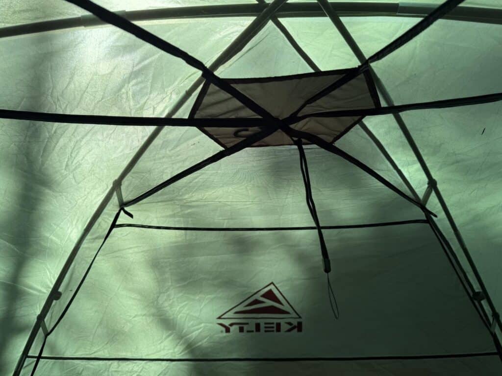 Looking up at the ceiling of the Kelty Wireless 6 with its crossing poles and a mesh panel