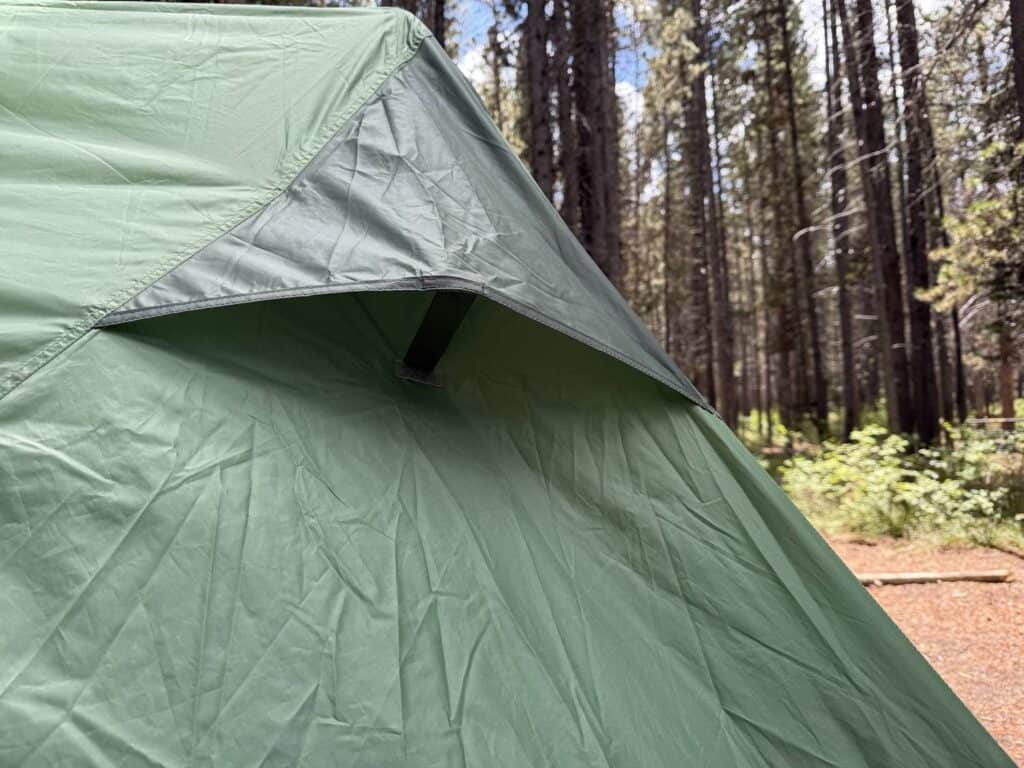 Kickstand vent propped open on the green rainfly of the Kelty Wireless 6