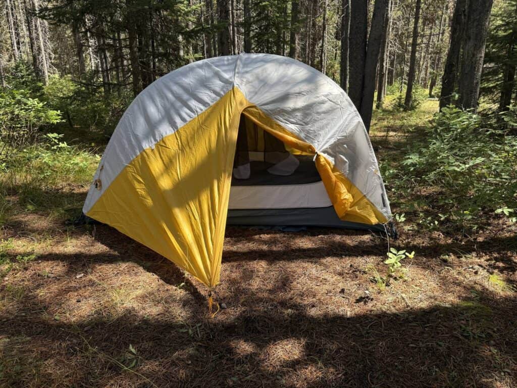 Mountain Hardwear Mineral King 3 with the vestibule door open at a forest campsite