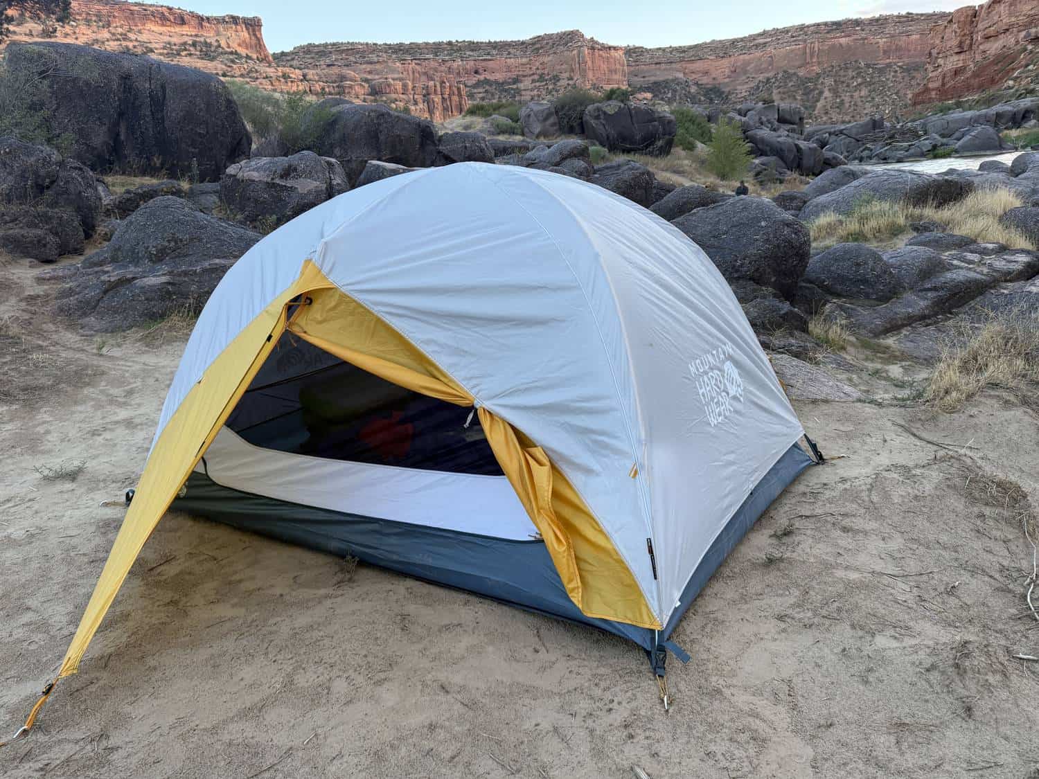 Mountain Hardwear Mineral King 3 pitched on sand at a red-rock river campsite with the door open