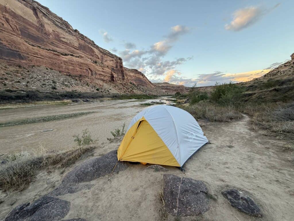 Mountain Hardwear Mineral King 3 pitched beside the Colorado River below red canyon walls