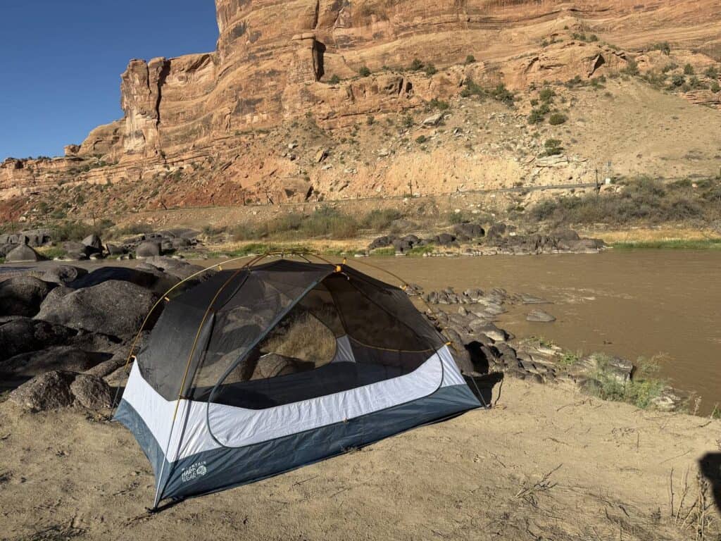Mountain Hardwear Mineral King 3 tent body without the rainfly next to a river in a red-rock canyon