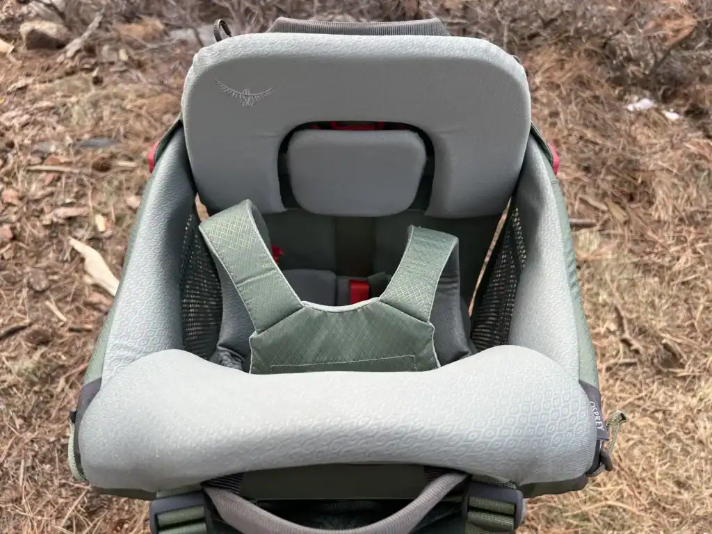 Padded child cockpit and harness of the Osprey Poco Premium child carrier