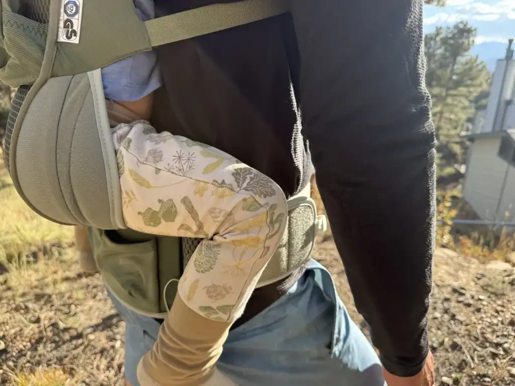 Close-up of a toddler seated in the mesh seat of the Osprey Poco Soft child carrier