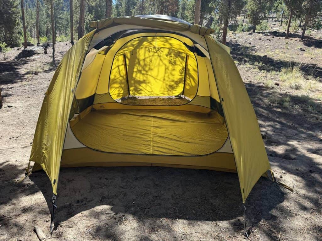 REI Co-op Base Camp 6 with the front vestibule door open in front of the tent door