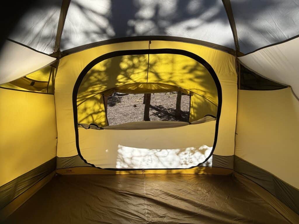 Inside the REI Co-op Base Camp 6 looking at a door with a mesh window