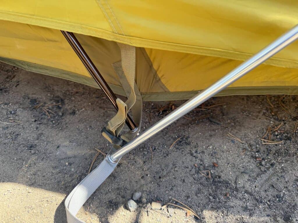 Aluminum pole seated at a corner webbing loop at the base of the REI Co-op Base Camp 6