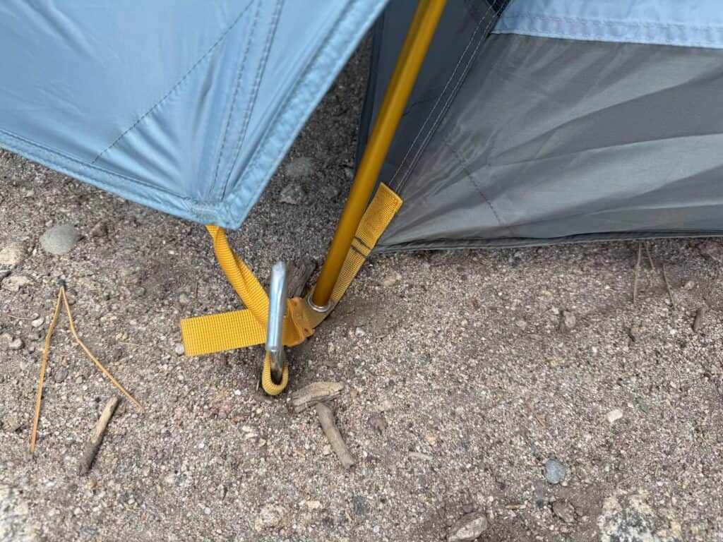 Yellow pole end seated at a corner of the REI Co-op Westward 6