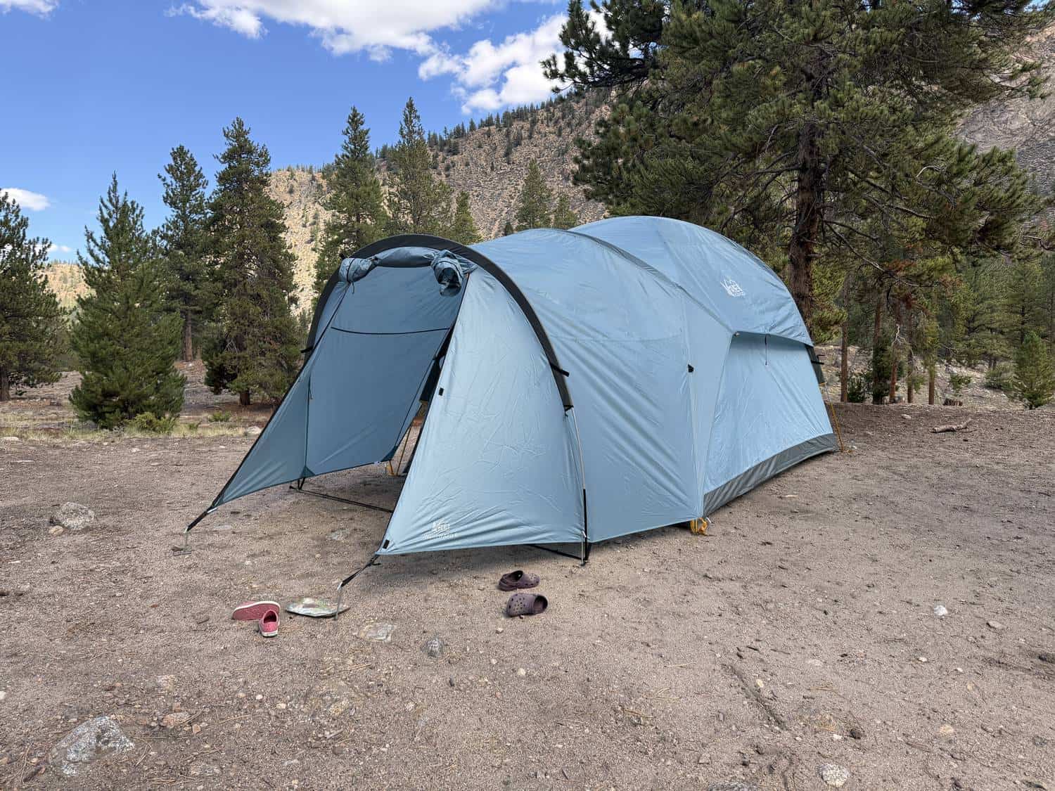 REI Co-op Westward 6 with its front vestibule pitched at a campsite in a mountain valley
