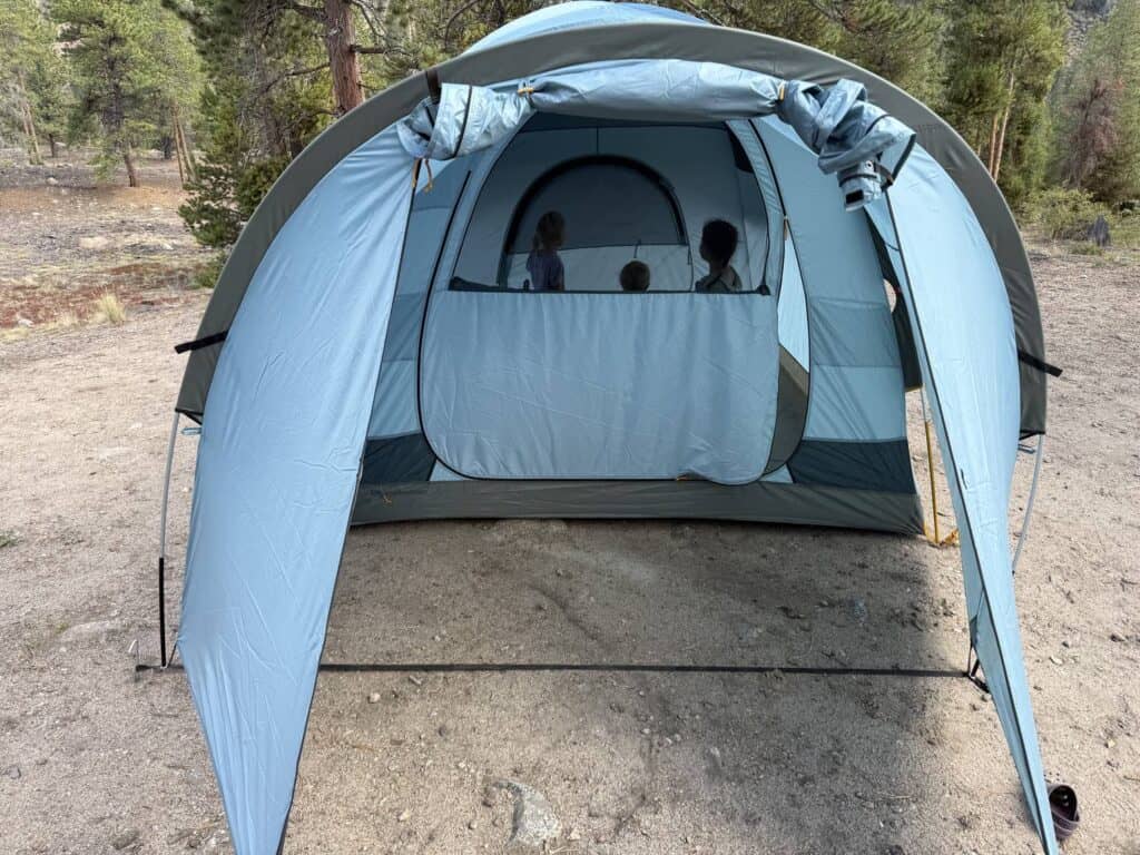 Front of the REI Co-op Westward 6 with the vestibule open and children inside the tent