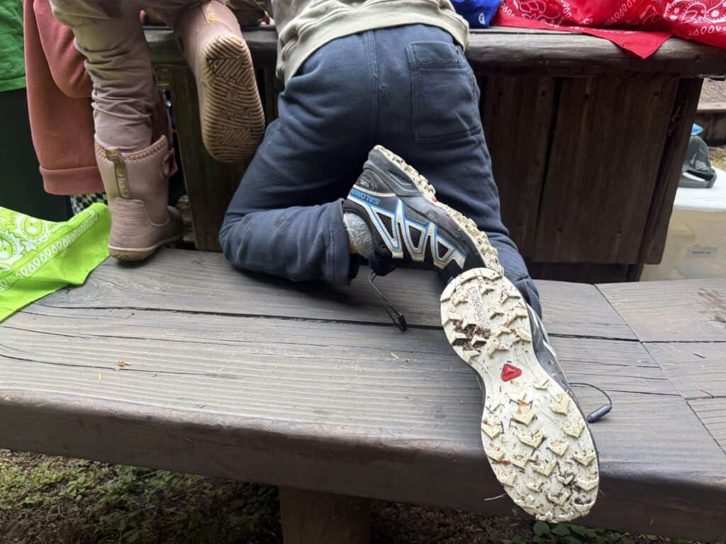 Sole of a Salomon Speedcross kids shoe showing deep chevron lugs