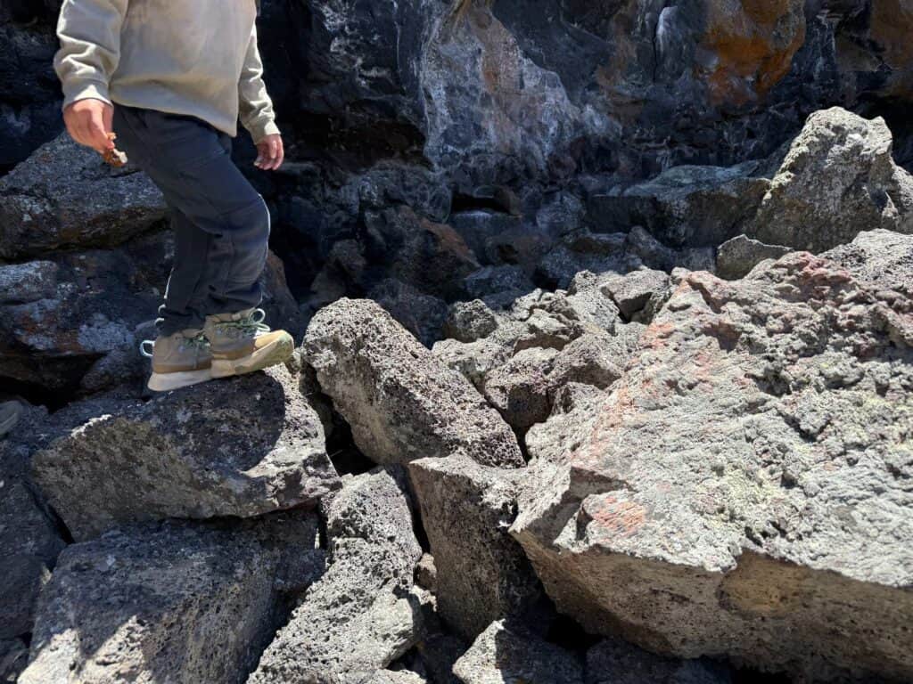 The North Face Fastpack II Mid Waterproof kids boots on jagged lava rock at Craters of the Moon, Idaho