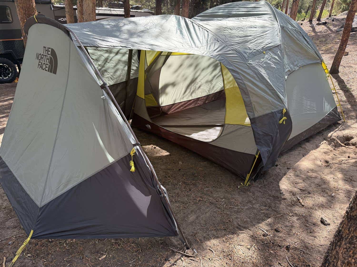 The North Face Wawona 6 tent pitched at a pine forest campsite with its large front vestibule open